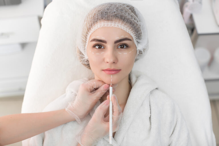 a woman lying on the bed and someone is injecting a syringe for anti aging treatments