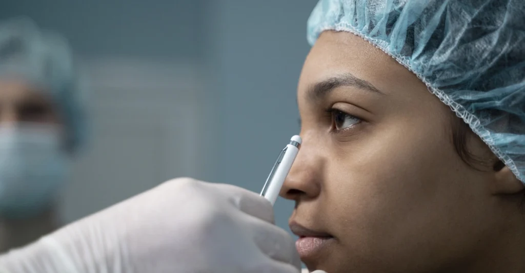 Doctor inspecting the face of patient before cosmetic surgery